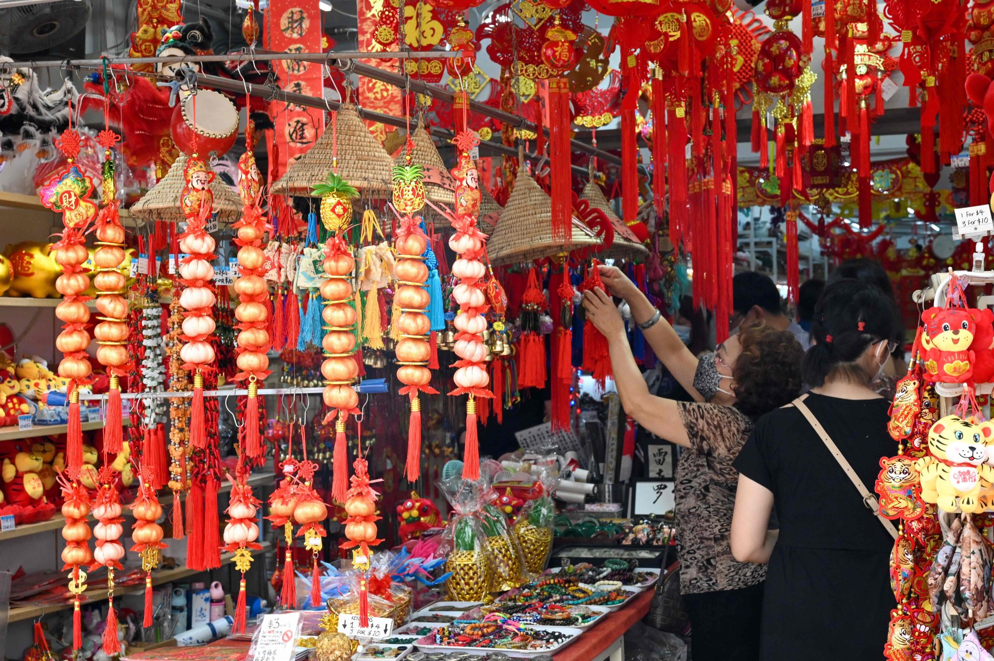 A woman looks at decorative ornaments on the eve of Lunar New Year in the Chinatown district of Singapore. Nair acknowledged that he knew the Chinese community would find his YouTube video offensive. Photo: AFP