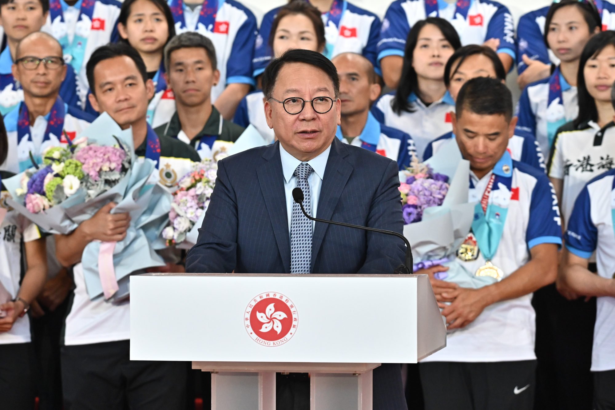 Chief Secretary Chan Kwok-ki welcomes home the disciplined services team that competed at the World Police and Fire Games in Canada. Photo: Handout