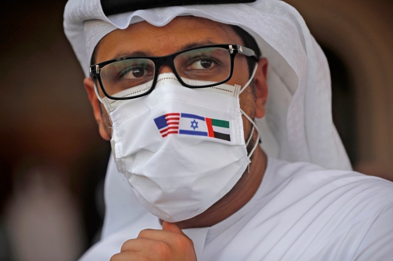 An Emirati man wears a protective mask with the flags of the United States, Israel, and the United Arab Emirates, on Aug. 31, 2020.