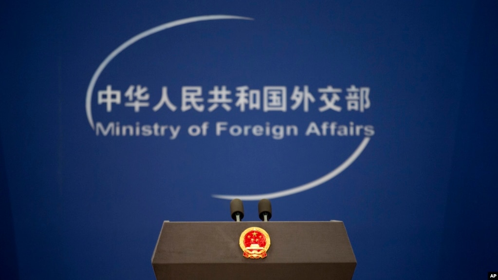 FILE - A podium with the national emblem of the People's Republic of China and a logo for China's Ministry of Foreign Affairs are seen before a daily briefing at the ministry's office in Beijing, China, Nov. 19, 2015.