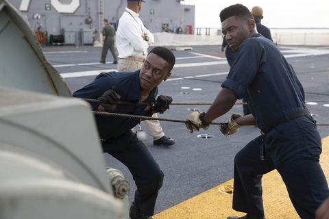 newport news, va oct 19, 2019 aviation boatswain's mate equipment airman isaiah gamble, left, from charlotte, north carolina, and aviation boatswain's mate equipment airman achigbue uche, from columbus, ohio, both assigned to uss gerald r ford's cvn 78 air department, reel a messenger cable while installing an arresting cable on the flight deck ford's air department installed the ship's arresting gear cables for the first time since undergoing their post shakedown availability us navy photo by mass communication specialist 2nd class brigitte johnston this image has been altered by blurring out badges for security purposes's mate equipment airman isaiah gamble, left, from charlotte, north carolina, and aviation boatswain's mate equipment airman achigbue uche, from columbus, ohio, both assigned to uss gerald r ford's cvn 78 air department, reel a messenger cable while installing an arresting cable on the flight deck ford's air department installed the ship's arresting gear cables for the first time since undergoing their post shakedown availability us navy photo by mass communication specialist 2nd class brigitte johnston this image has been altered by blurring out badges for security purposes