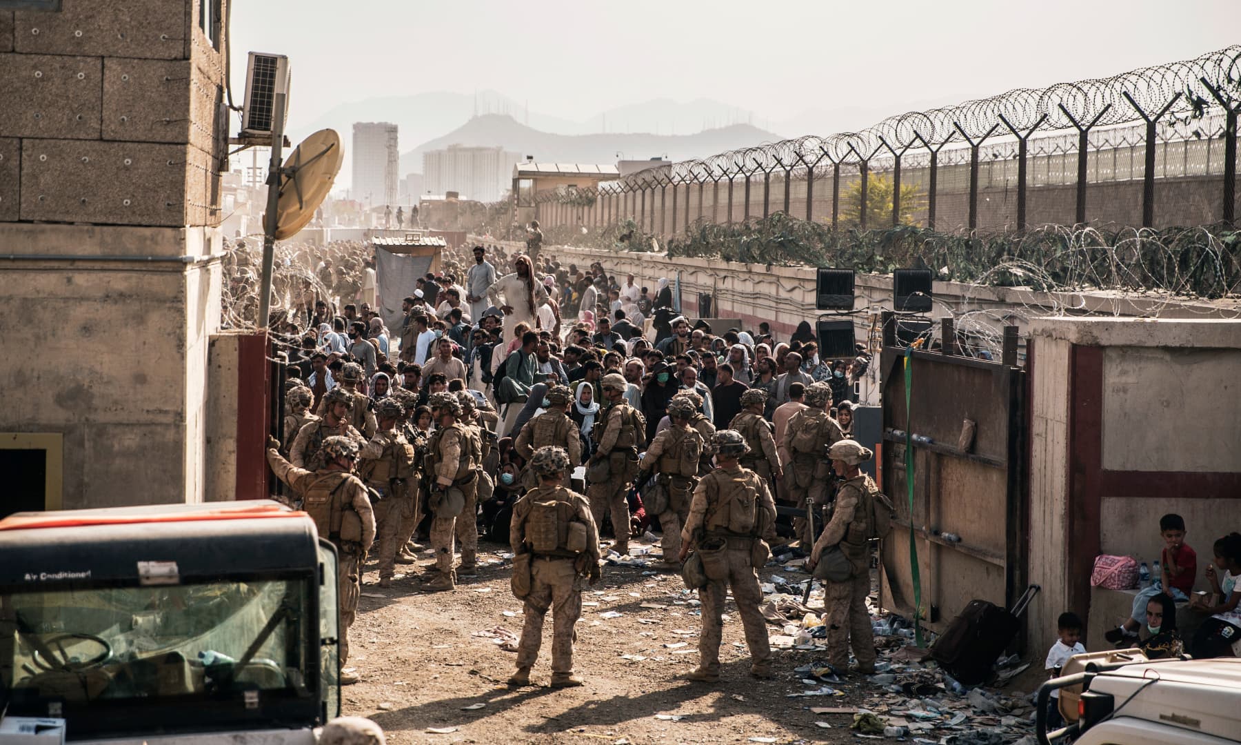 US Marines with Special Purpose Marine Air-Ground Task Force - Crisis Response - Central Command, provide assistance at an evacuation control checkpoint during an evacuation at Hamid Karzai International Airport in Kabul, Afghanistan on August 21, 2021. — AP