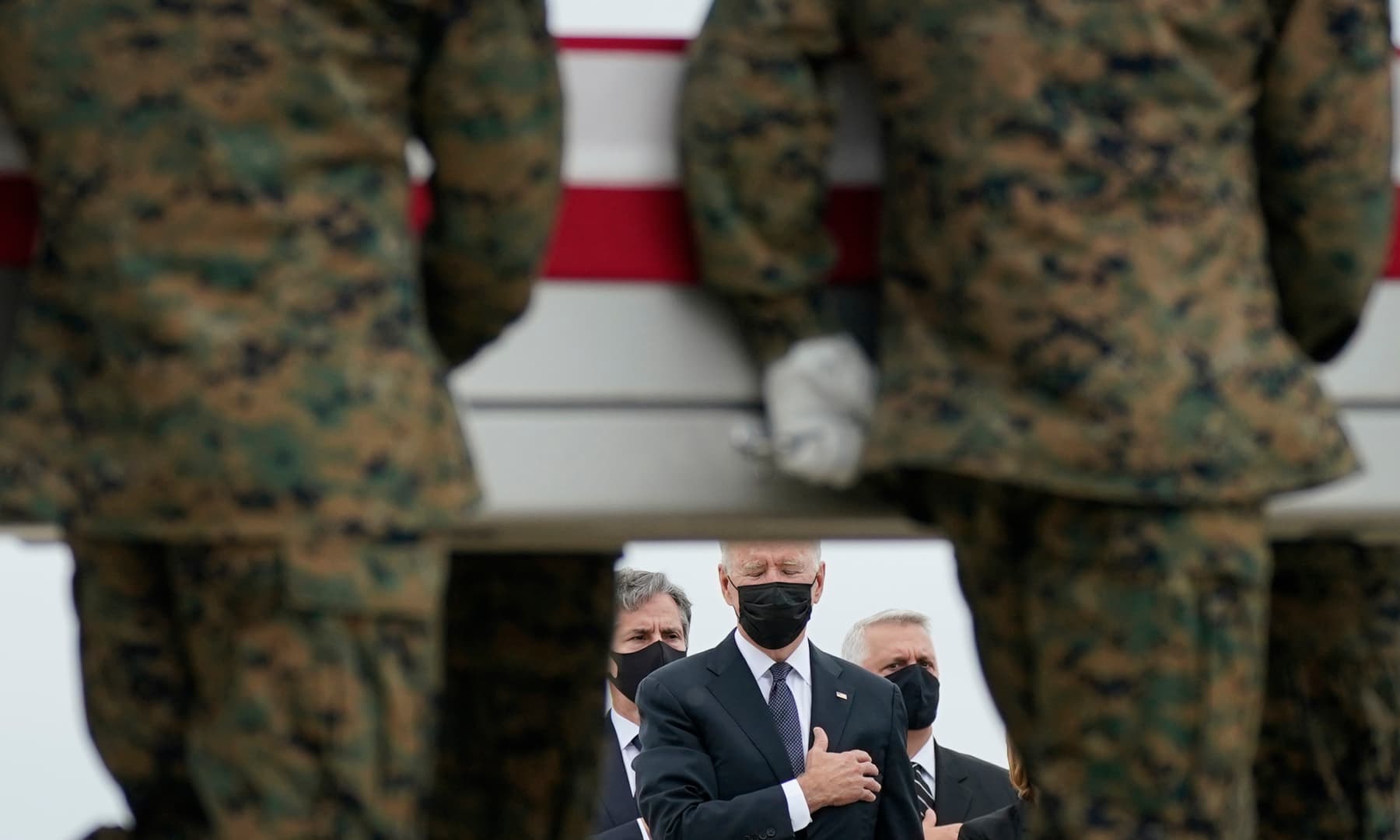 President Joe Biden watches as a carry team moves a transfer case containing the remains of Marine Corps Lance Cpl Kareem M Nikoui, 20, of Norco, California, during a casualty return at Dover Air Force Base, Delaware, US on August 29, 2021. — AP