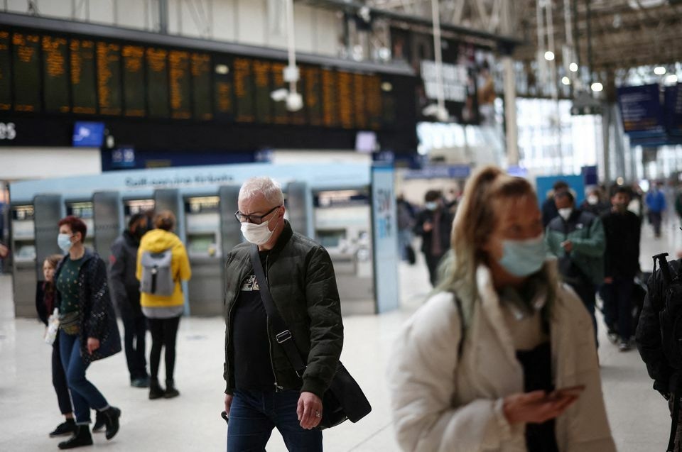 People wearing protective face masks walk through Waterloo train station in London, Britain, January 3. — Reuters