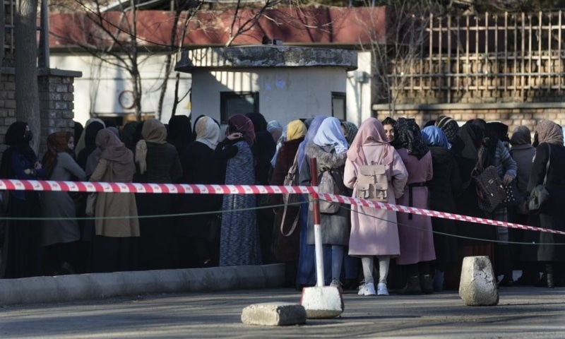 Afghan Students queue at one of Kabul University's gates, in Kabul, Afghanistan, Feb 26. — AP