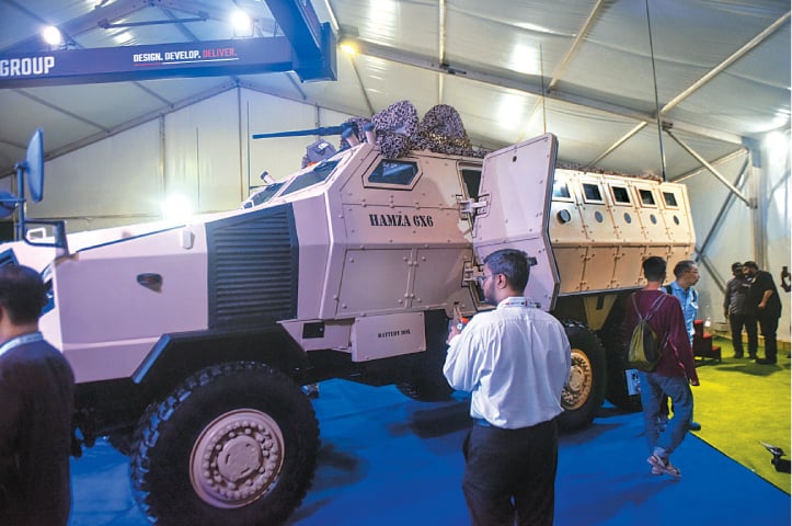 KARACHI: Visitors to IDEAS 2022 view the Hamza 6x6 multi-role combat vehicle at the pavilion of Cavalier Group, a private-sector arms manufacturer based in Islamabad, on Wednesday.—Fahim Siddiqi / White Star