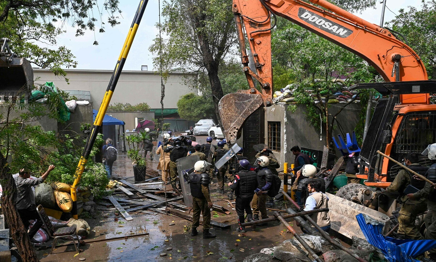 Policemen use heavy machinery to enter Pakistan’s former prime minister Imran Khan’s residence in Lahore on March 18, 2023, after Khan left for Islamabad to appear in a court.— Photo by Arif Ali/AFP