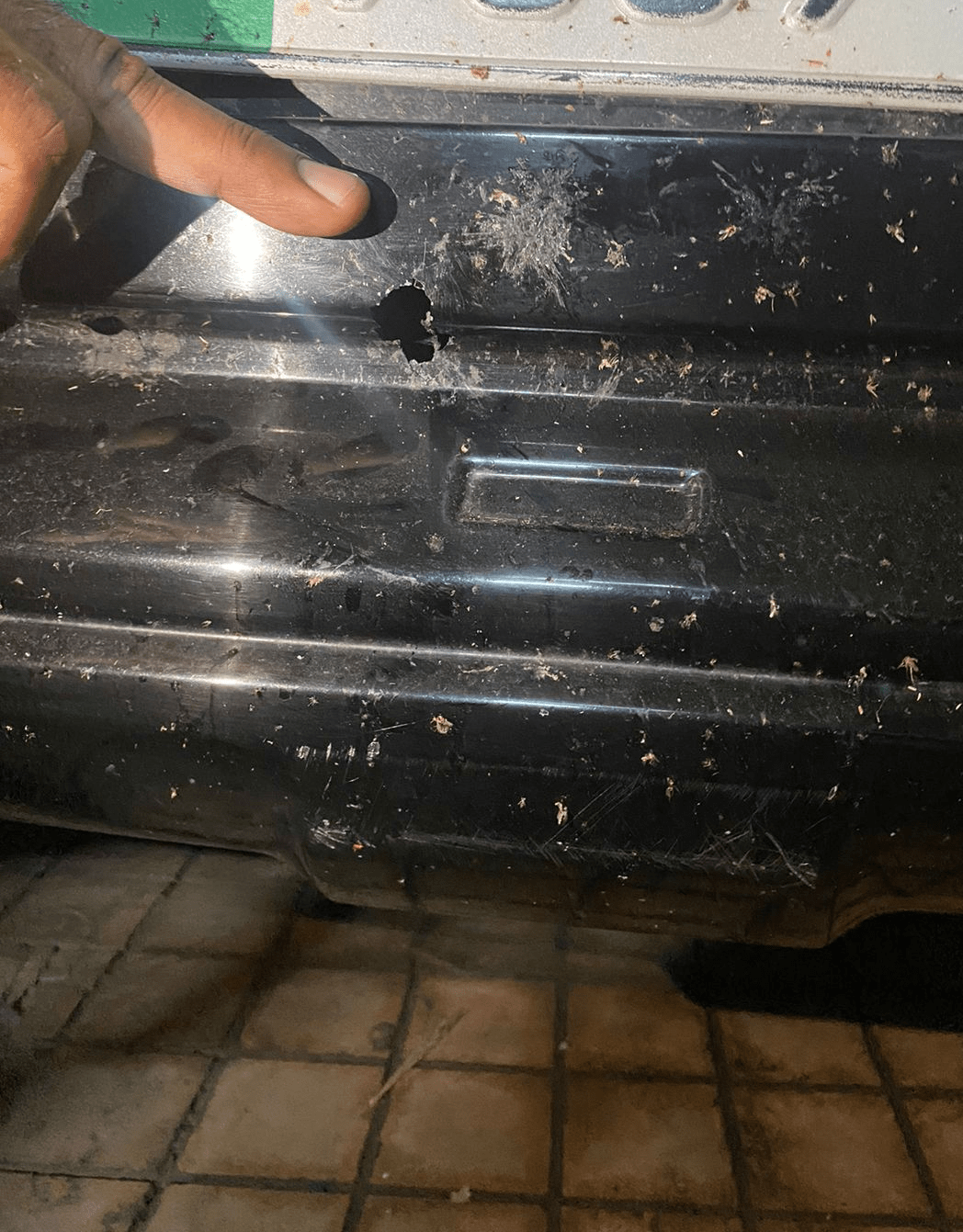 A bullet hole is seen in the bumper of Latif Khosa’s car after unknown men opened fire at his Lahore house in the early hours of Friday. — Photo provided by Wasim Riaz