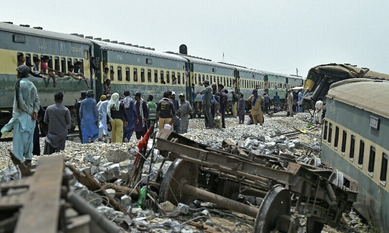 Workers repair a damaged track, a day after the derailment of a passenger train in Nawabshah on August 7, 2023. — AFP