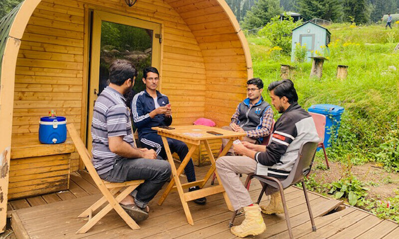 Travellers photographed outside a camping pod in in Gabin Jabba, Swat. — Photo by author