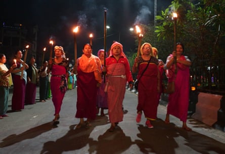 Protesters, holding a torchlight vigil for return of peace, in Imphal, the capital of Manipur