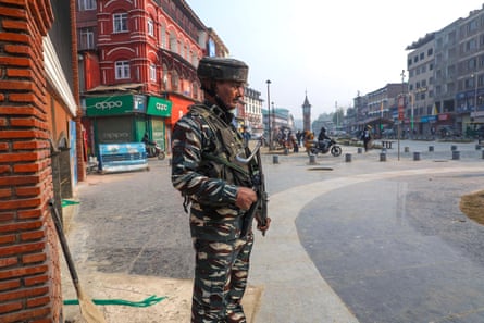 An armed soldier stands guard on a street in Srinagar.
