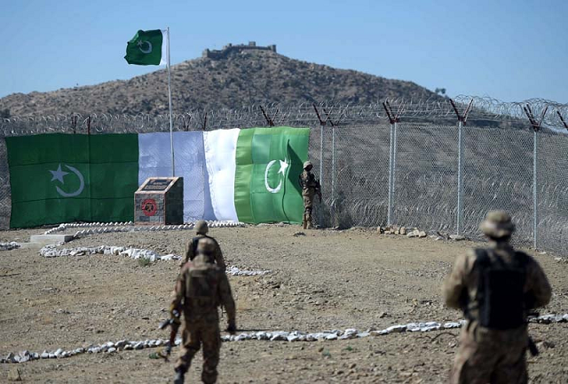 a pakistani soldier keeps vigil at the border fencing along with afghanistan photo afp file