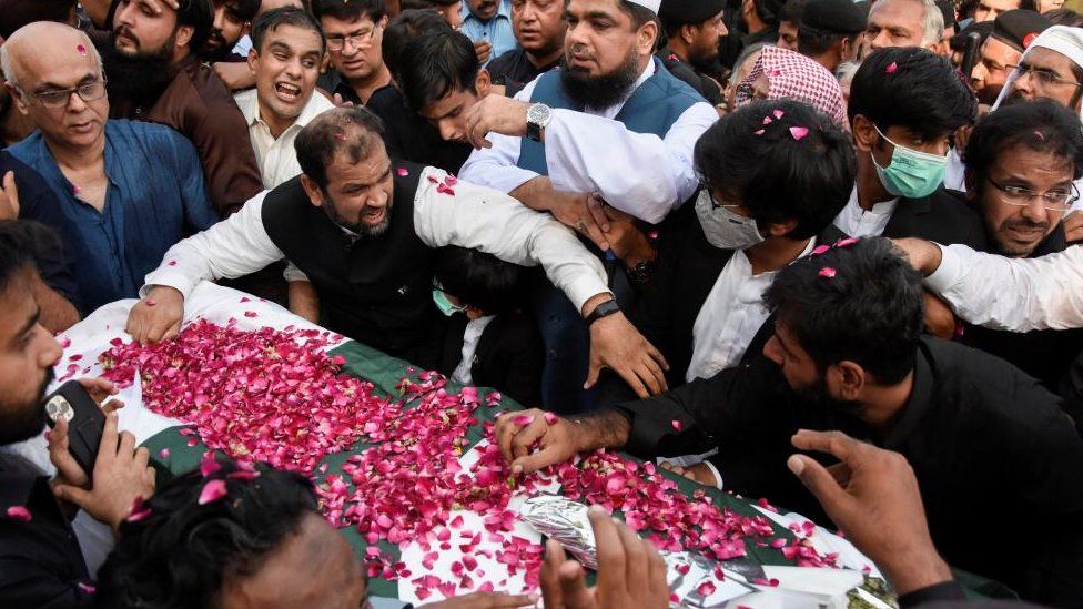 Men gather around a coffin as they attend a funeral of journalist Arshad Sharif, who was killed in a police shooting in Kenya, at Faisal mosque in Islamabad, Pakistan October 27, 2022