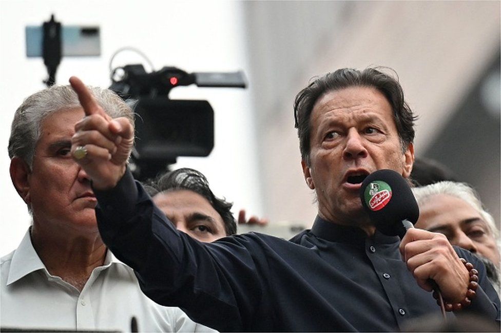 Pakistan's former prime minister Imran Khan (R) addresses his supporters during an anti-government march towards capital Islamabad, demanding early elections, in Gujranwala on November 1, 2022