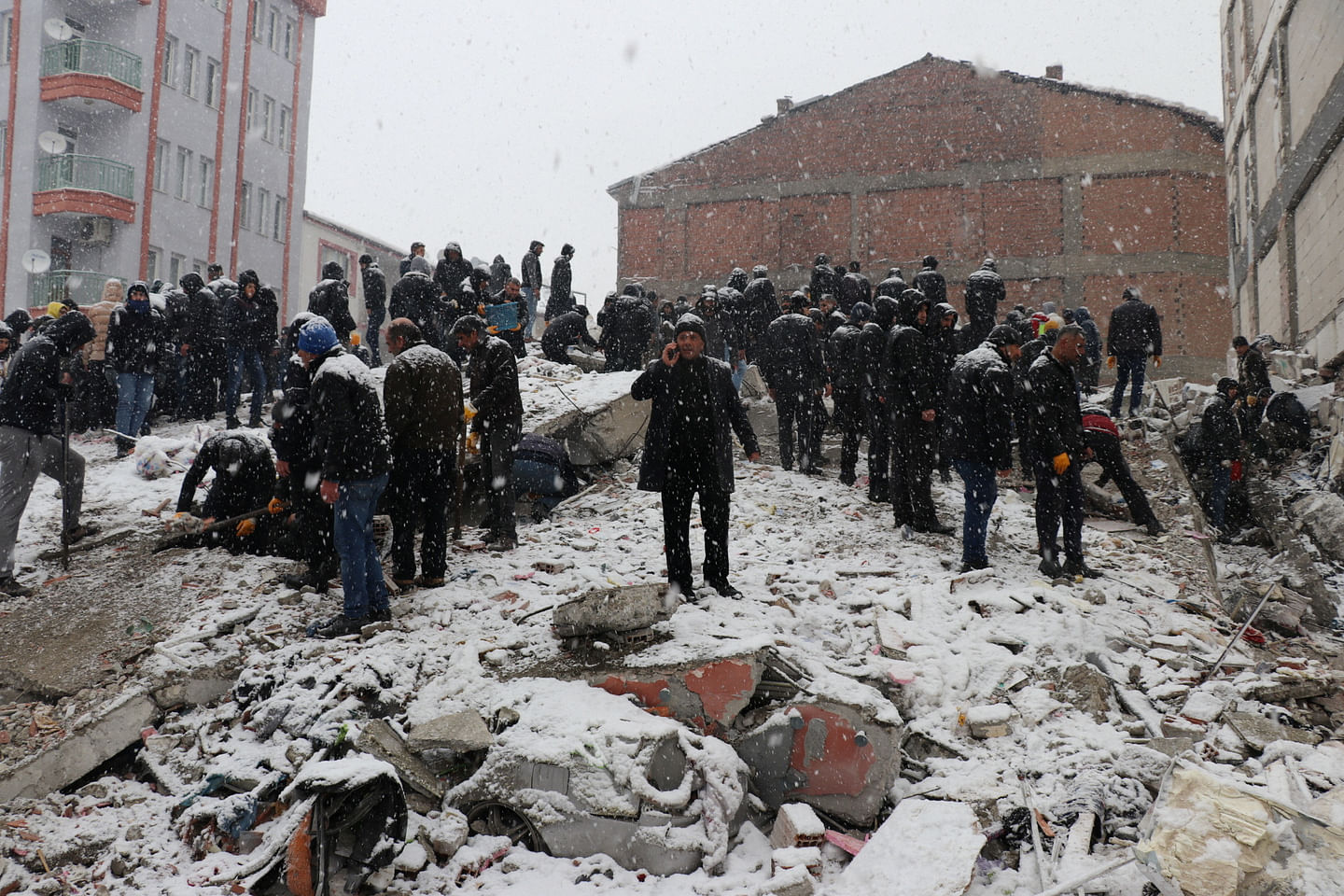 Rescuers carry out a person from a collapsed building after an earthquake in Malatya, Turkey February 6, 2023