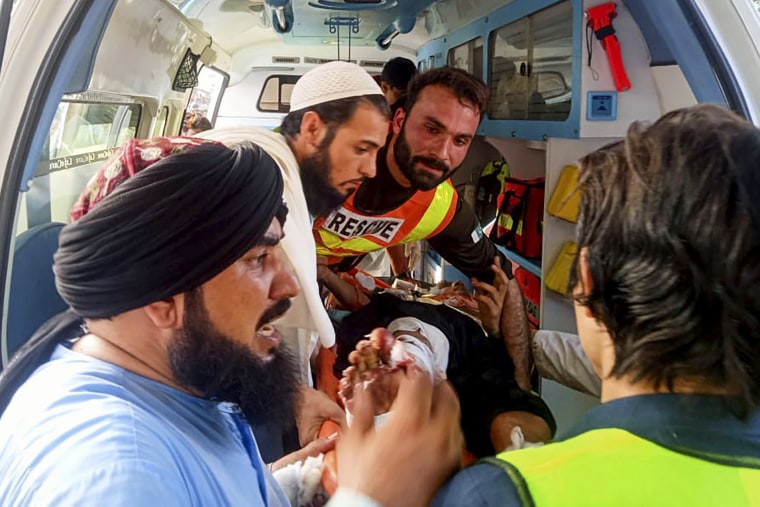 Rescue workers carry a wounded man after a bomb explosion in the Bajur district of Khyber Pakhtunkhwa, Pakistan, on July 30, 2023.