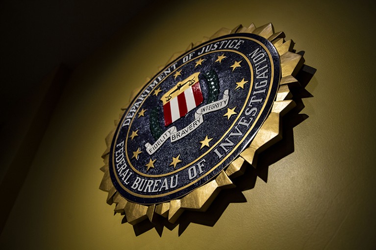 The seal of the FBI hangs on a wall.