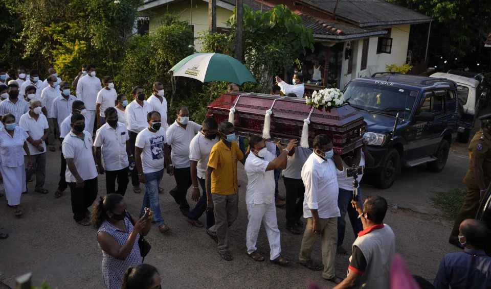 Family members of Sri Lankan factory manager Priyantha Kumara who was lynched by a Muslim mob in Pakistan for alleged blasphemy carry his casket to a cemetery during his burial in Colombo, Sri Lanka, Wednesday, Dec. 8, 2021. (AP Photo/Eranga Jayawardena)