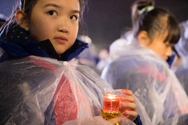 depositphotos_237559820-stock-photo-young-girls-hold-candles-rain.jpg