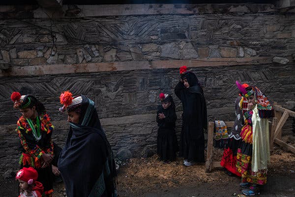 Kalash women awaiting the purification ceremony at the start of the festival.    