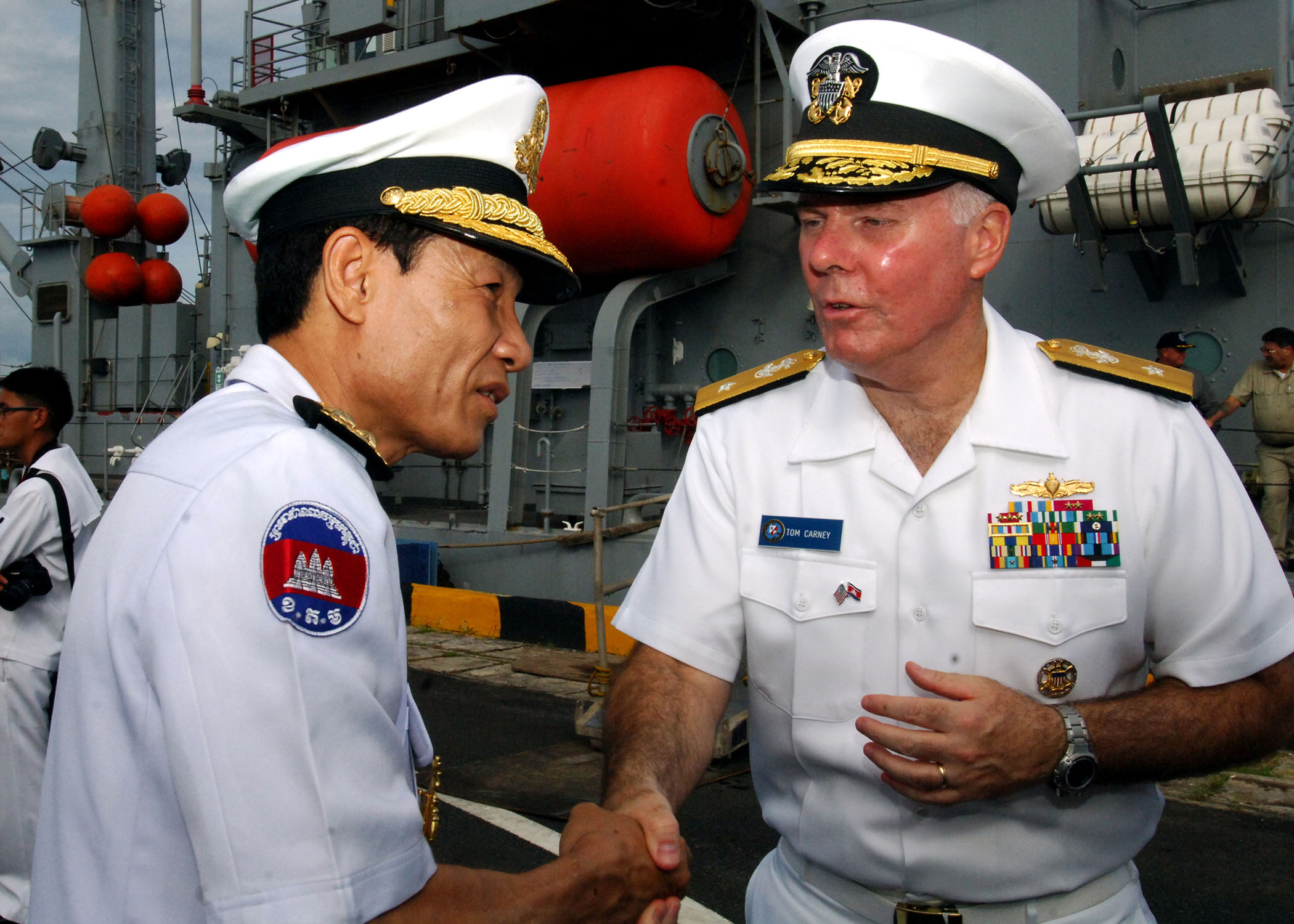 US_Navy_111020-N-NJ145-140_Royal_Cambodian_Navy_Vice_Adm._Ouk_Seyha_thanks_U.S._Navy_Rear_Adm._Tom_Carney,_commander_of_Task_Force_73,_after_tourin.jpg