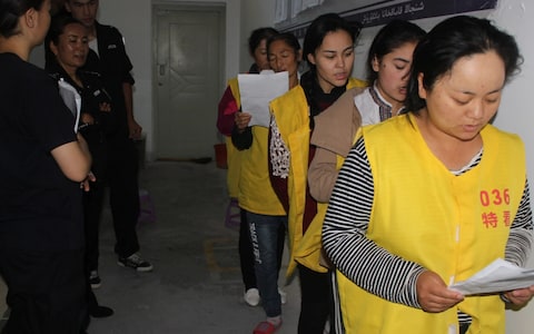 An image from inside the rarely seen confines of a detention centre, which appears to show Uyghurs being “re-educated”