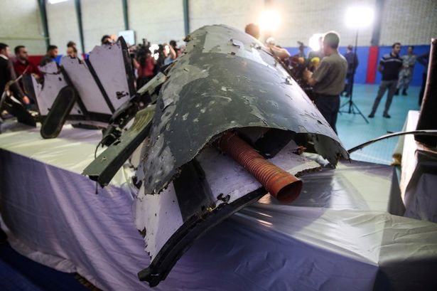 0_The-purported-wreckage-of-the-American-drone-is-seen-displayed-by-the-Islamic-Revolution-Gua...jpg