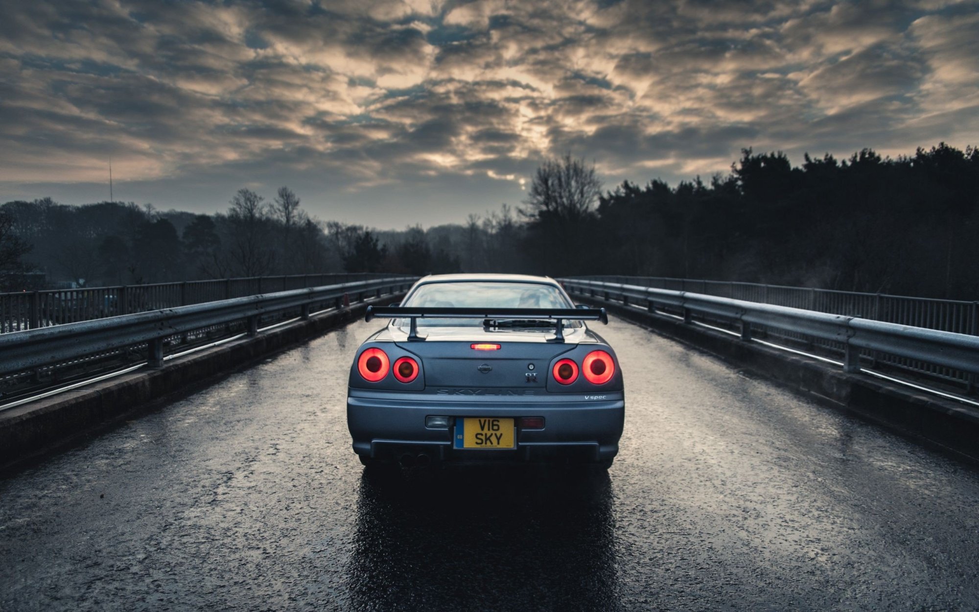 474018-car-Nissan-Nissan_Skyline_GT-R_R34-blue_cars-rain-trees-sky.jpg