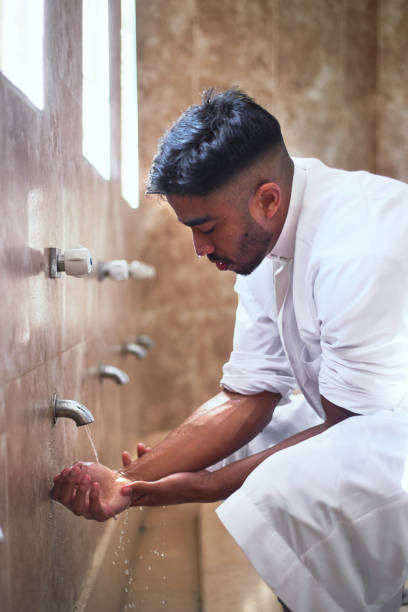 a-young-muslim-man-performs-wudu-during-prayers-at-a-mosque.jpg