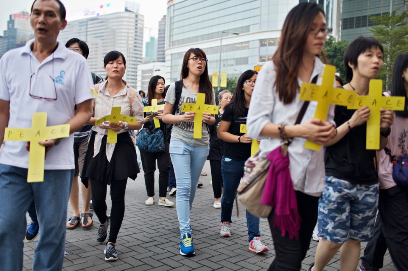 Catholics calling for peace near a protest site.jpg