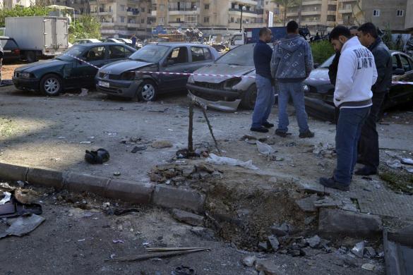 Civilians inspect a site of a roadside.jpg