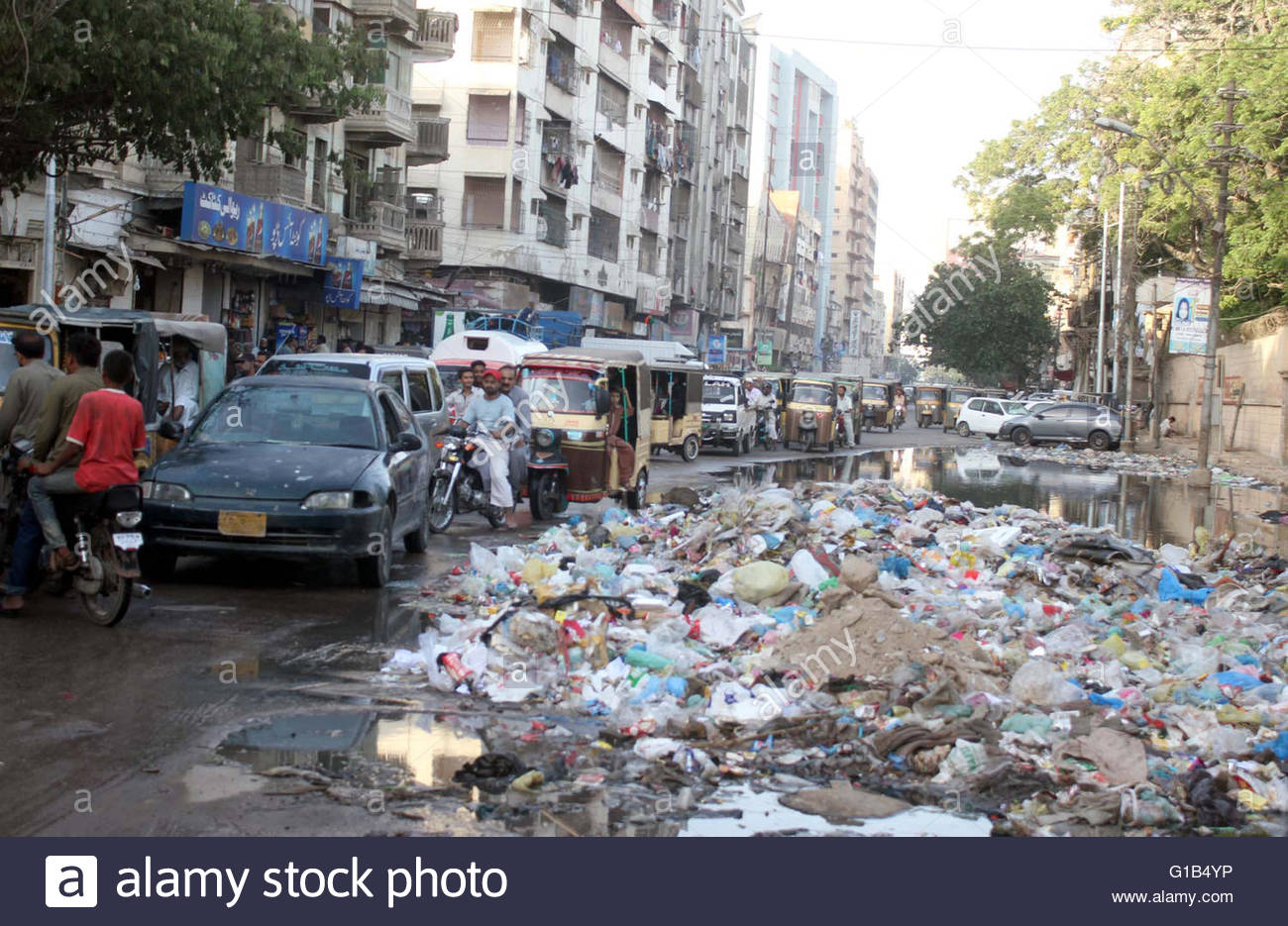 huge-heap-of-garbage-and-flowing-gutter-water-showing-negligence-of-G1B4YP.jpg