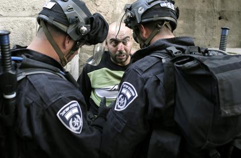 Israeli riot police arrest a Palestinian at the.jpg