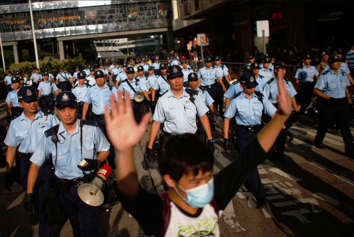 Police officers try to dispense the crowd near the government headquarters..jpg
