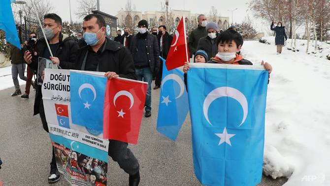 the-protesters-waved-sky-blue-flags-of-uyghur-separatists--self-proclaimed-state-of-east-turke...jpg