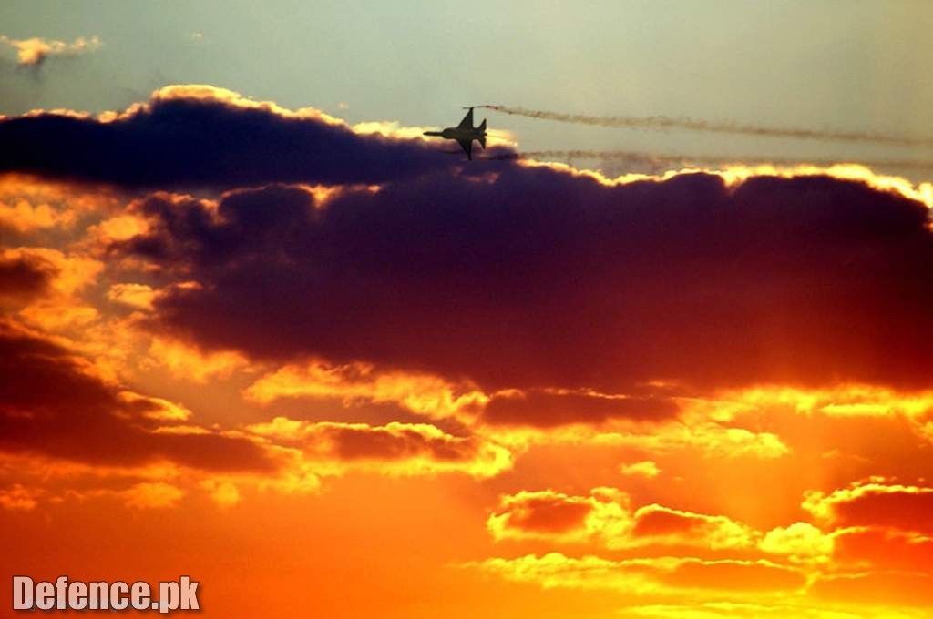 A smoking JF-17 on golden sky.