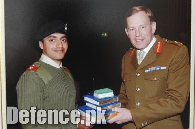 Queen Elizabeth of Britain awarding â€œSword of Honourâ€￾ to Pakistani Officer