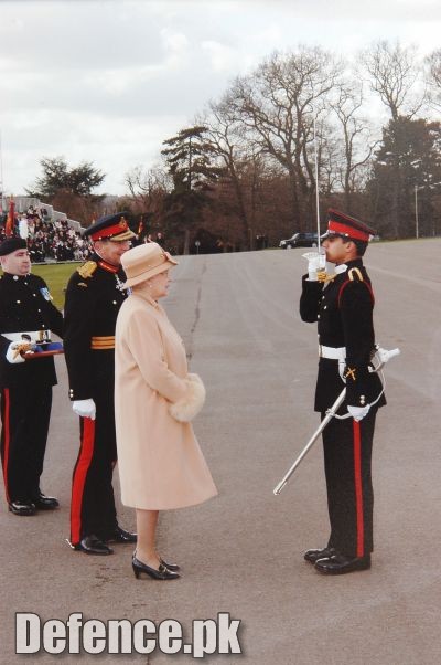 Queen Elizabeth of Britain awarding â€œSword of Honourâ€￾ to Pakistani Officer