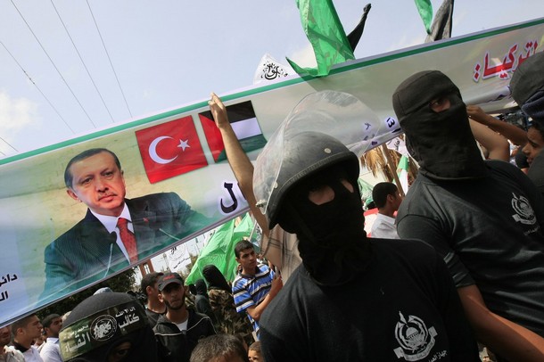 Masked+Hamas+militants+hold+a+banner+bearing+the+portrait+of+Turkish+Prime+Minister+Recep+Tayyip+Erdogan+and+the+Turkish+and+Palestinian+flags+during+a+rally+organized+by+the+Islamist.jpg