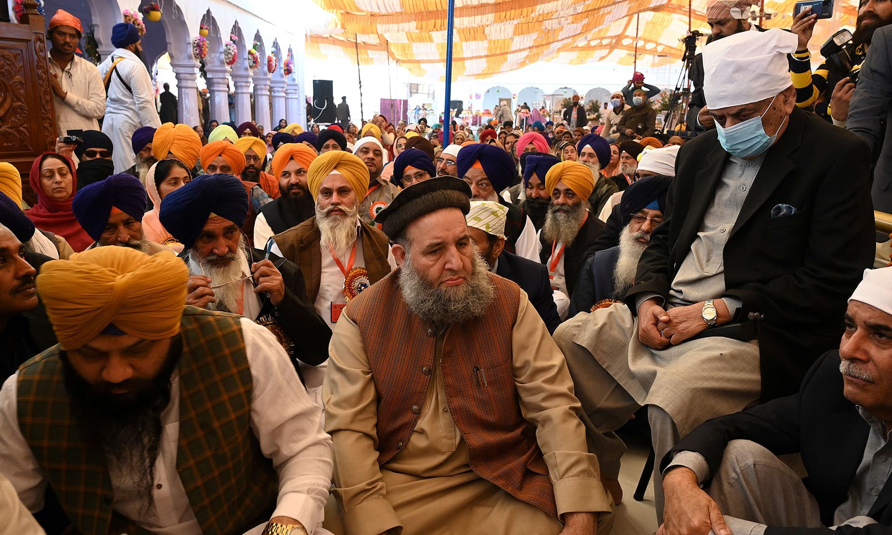 Minister for Religious Affairs Noorul Haq Qadri (C) attends a ceremony during a Sikh religious procession in Nankana Sahib on Friday. — AFP