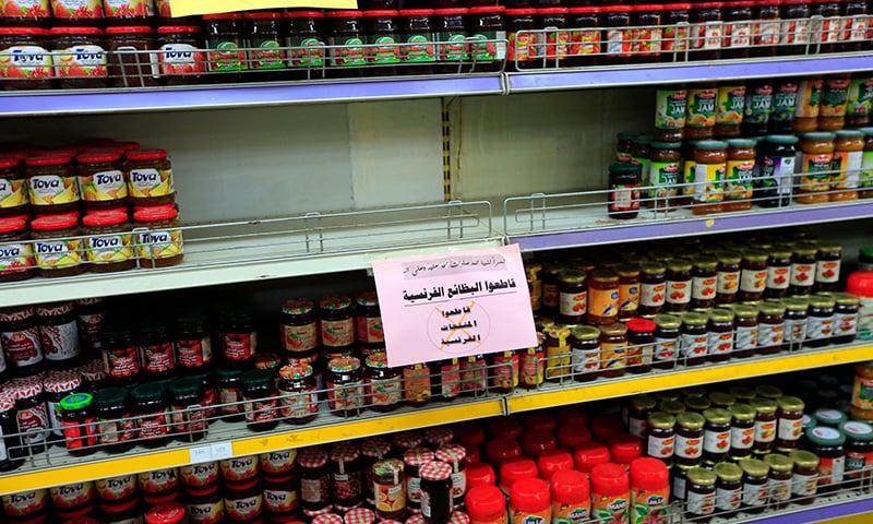 Signs in Arabic calling customers to boycott French products are placed on shelves at a supermarket in the Yemeni capital Sanaa. — AFP