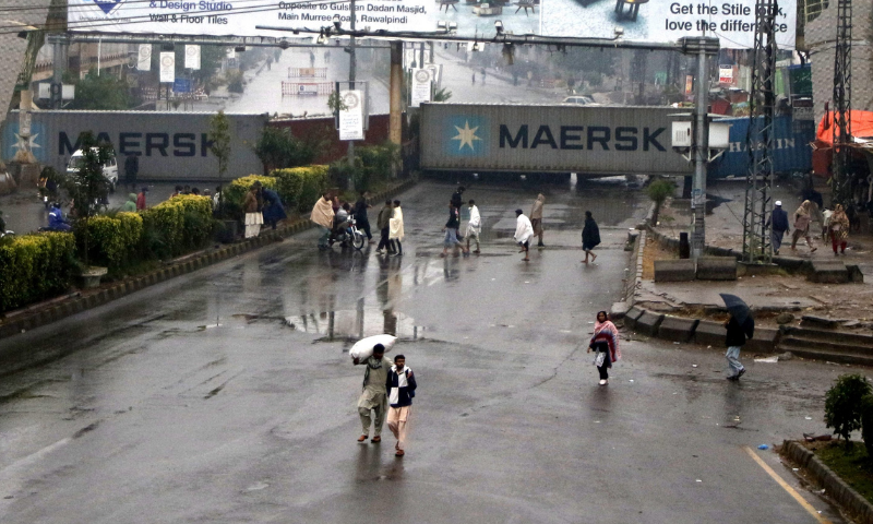 A view of Murree Road blocked with containers before TLP activists approach Islamabad. — Mohammad Asim/White Star