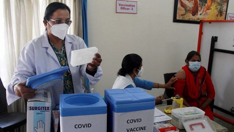 Health workers prepare for the dry run of COVID-19 vaccine at a community centre, in Gurugram, on 7 January 2021 | PTI Photo