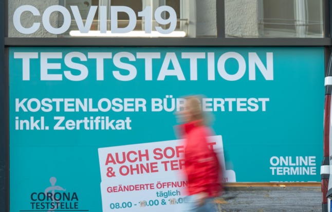 A woman walks past a Covid test station in Munich in August. 