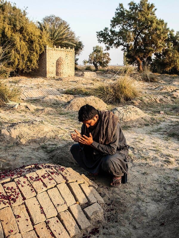 Abdul in February at Farhan’s grave the day after he died.