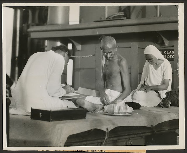 Mahatma+Gandhi+at+work+during+his+voyage+from+India+to+London+-+1931.jpg