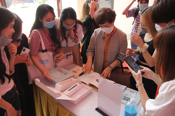 Vietnamese students and faculty at Thang Long University in Hanoi check out Korean language study material provided by global K-pop sensation BTS, on Aug. 27, 2020, in this photo provided by Korean News in Hanoi.