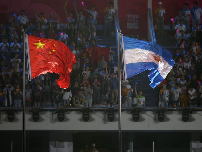 The flags of China and Argentina during the closing ceremony for the Nanjing 2014 Summer Youth Olympic Games.