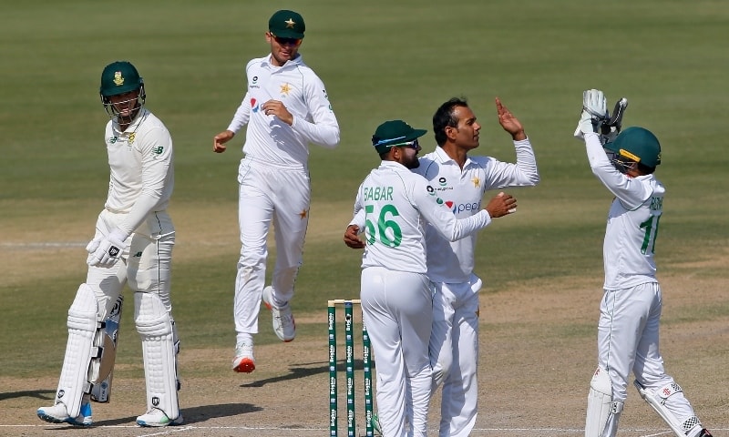 Pakistan's spinner Nauman Ali, second right, celebrates with teammates after taking the wicket of South Africa's George Linde, left, during the fourth day of the first cricket test match between Pakistan and South Africa at the National Stadium on Jan 29. — AP